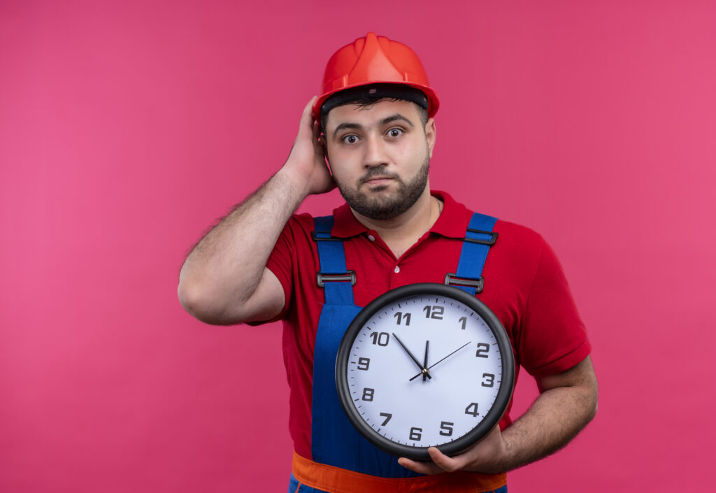 man holding clock against pink background