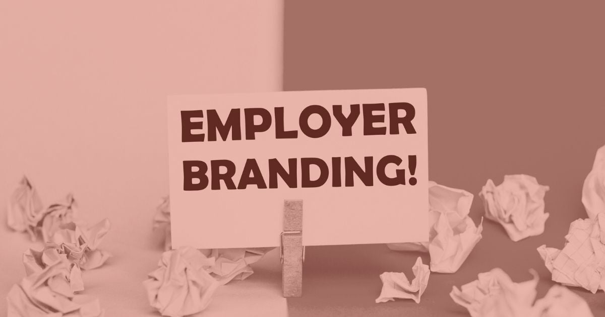 Sign reading “Employer Branding” surrounded by crumpled paper, symbolizing the challenge of standing out in a crowded hiring market.