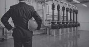 Manufacturing leader standing inside a modern production facility